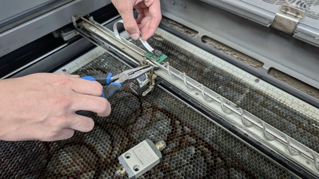 Servicing an Epilog laser, replacing a component on the gantry inside the machine